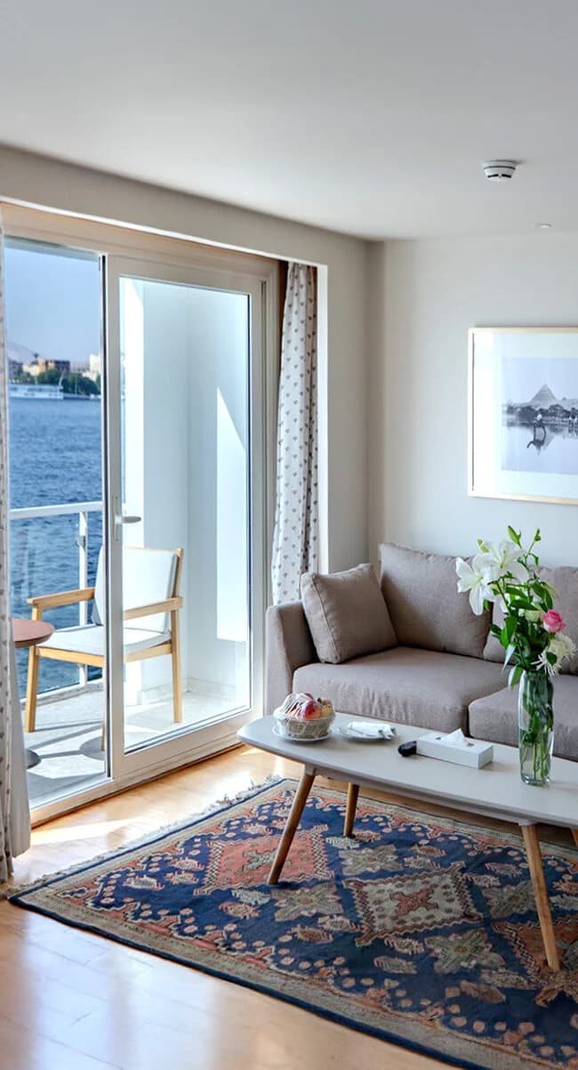 Suite living area opening onto a private balcony on the Ellie Nile Cruise