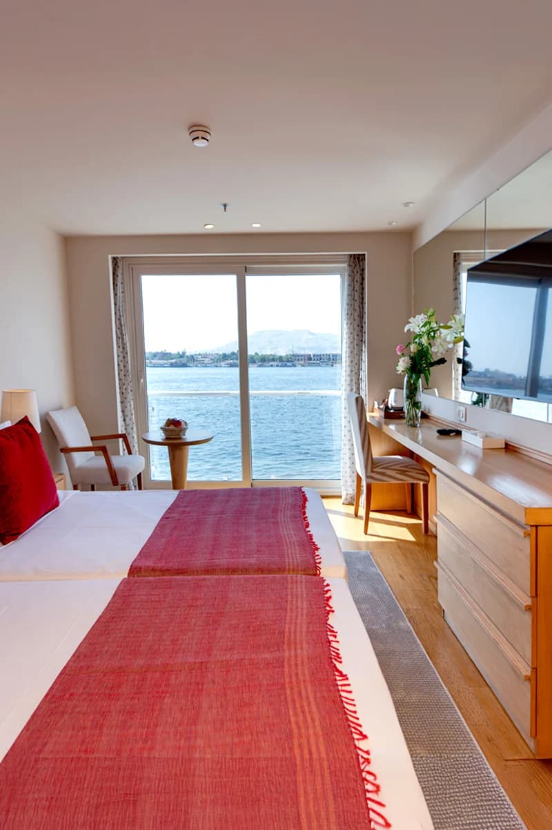 Cabin with river views and a writing desk on the Ellie Nile Cruise